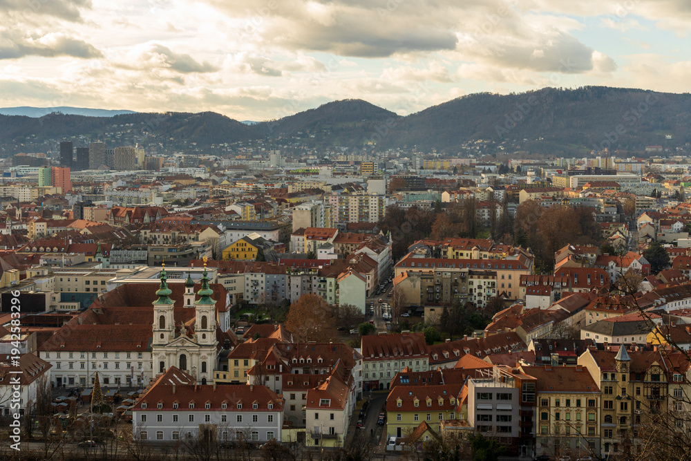 Fototapeta premium Cityscape with Red Tile Roofs, Church Towers and Hills