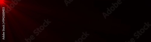 Abstract shimmering red light rays burst and rotate slowly, creating dynamic optical flare effect on a completely dark background. Sun rays effect footage overlay.