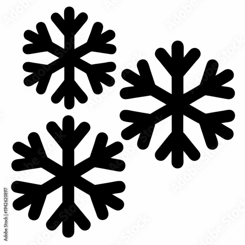 Three simplistic black snowflakes randomly placed on a bright white background
