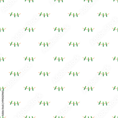 Green clothespins hanging on horizontal ropes creating a seamless background pattern