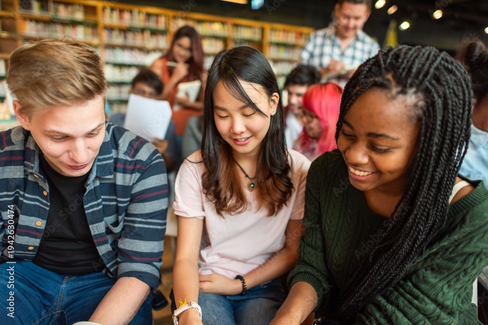 Fototapeta premium Diverse students studying together happily.