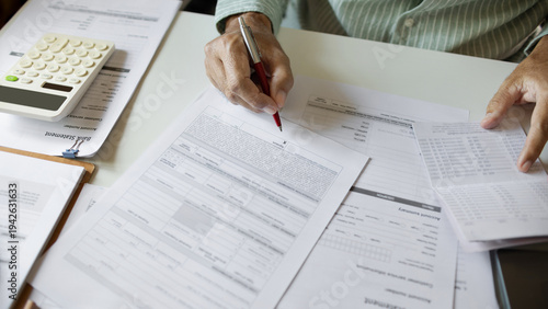 Canvas Print close up shot, man hand holding pen checking business contract, passbook and oth