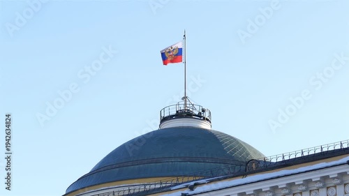 Swaying standard of the President of the Russian Federation on the cupola of Senate building in Moscow Kremlin. Sunny day