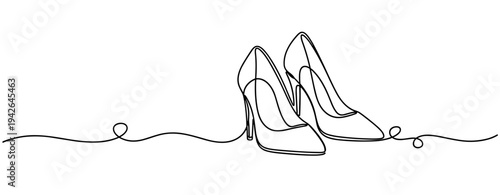 Pair of high heel shoes positioned on continuous line surface