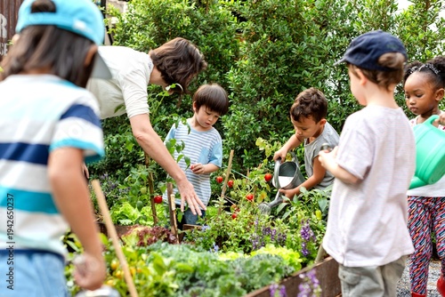 Tableau sur toile Children gardening with adult supervision.