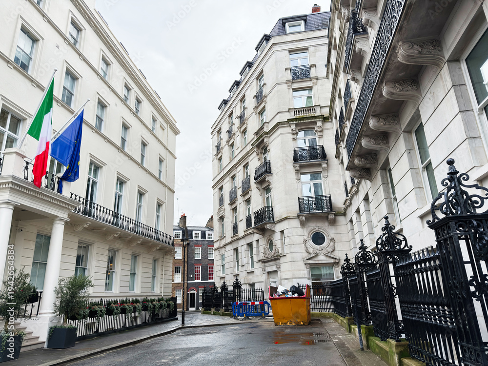 Fototapeta premium London street scene with Italy and EU flags, historic buildings, and ornate iron fencing