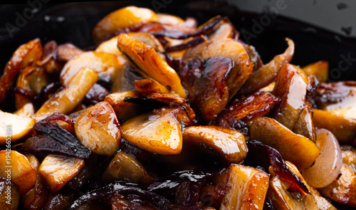 Fried mushrooms with onions on a white background. High quality photo