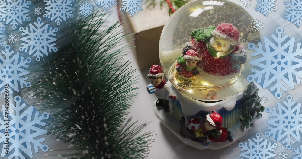 Obraz premium Showing lit snow globe on holiday tabletop with glittering Santa base and pine, copy space