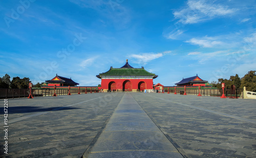 A scenic view of the Danbi Bridge at Beijing’s Temple of Heaven Park with traditional architecture and expansive stone paths under a clear blue sky.