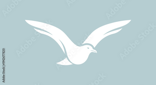 Minimalist white flying bird icon. Stylized graphic illustration of a graceful seagull or dove in flight with outstretched wings on light blue.