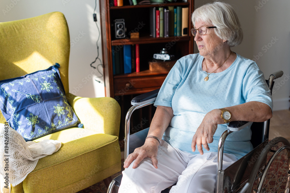 Obraz premium Elderly woman in wheelchair indoors.