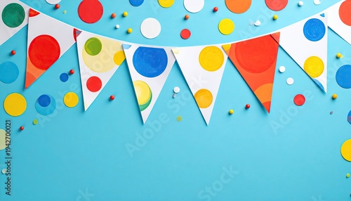 Colorful bunting and confetti on light blue background, top-down view