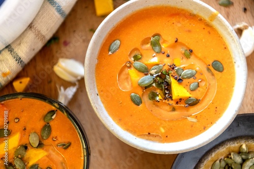 Photography Creamy pumpkin soup garnished beautifully.
