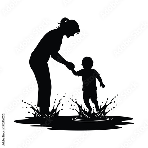 Mother and child playing together in puddle on sunny day