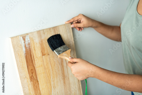 Canvas Print Person painting wooden surface.