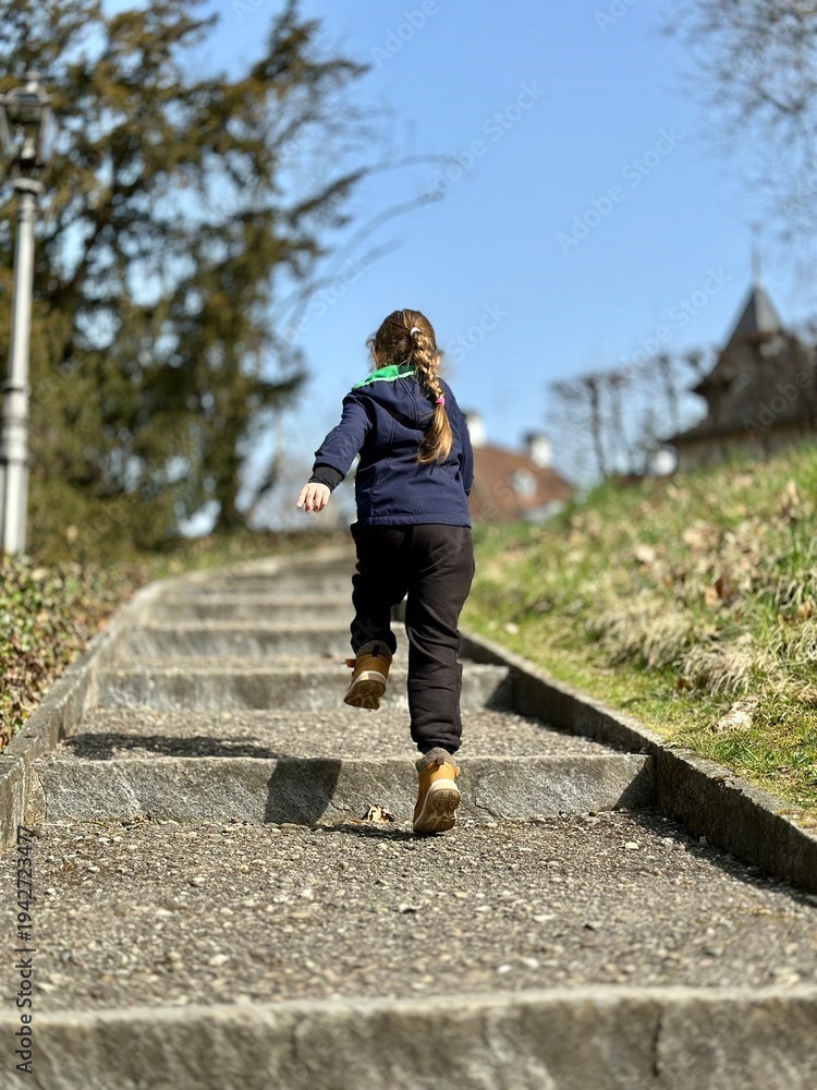 Fototapeta premium little girl running in the park