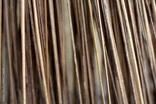 Brown background, pattern from coconut leaf stem.
broom stick texture close up.  broomstick abstract background.
