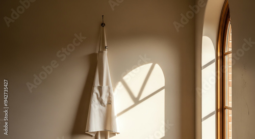 white robe hanging by window with natural light