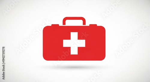 Red medical first aid kit box with white cross on lid handle and subtle shadow on clean background