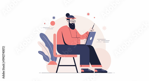 Bearded man in glasses working on a laptop and holding a stylus