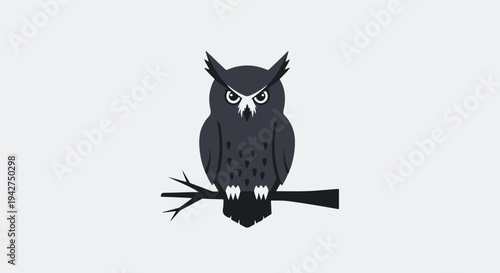 A black owl sitting on a branch looking angry or surprised