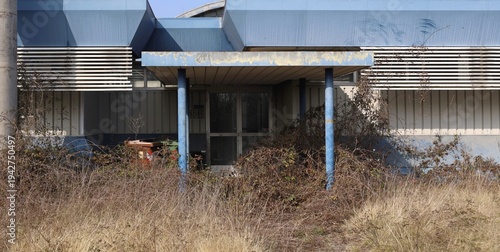 Wallpaper Mural Entrance of long time abandoned disco bar with overgrown weeds in front of the entry porch.  Background for copy space. Torontodigital.ca