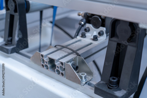Industrial aluminum profile structure and mounting hardware on a machine.