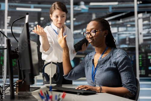 Fotografia Data center engineer doing talk to the hand gesture, being dismissive of coworker berating her, reproaching performance issues