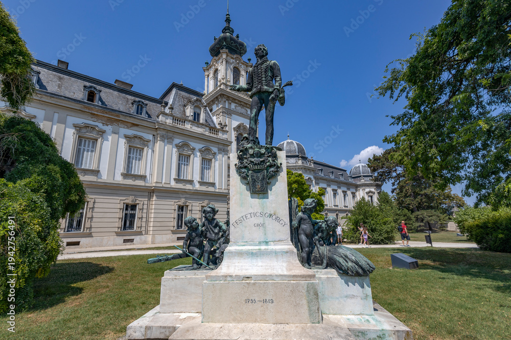 Fototapeta premium KESZTHELY, HUNGARY, JULY 17, 2024 - The statue of Count Gyorgy Festetics of Tolna, located in front of the famous Festetics Palace in Keszthely, Hungary