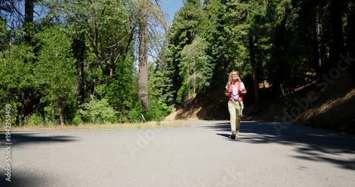 Wallpaper Mural Woman Walking on Road Amidst Forest Trees Torontodigital.ca