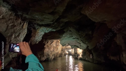 A view of the underground river in Trang An, Ninh Binh, Vietnam. Tourists visit to experience the natural wonder.