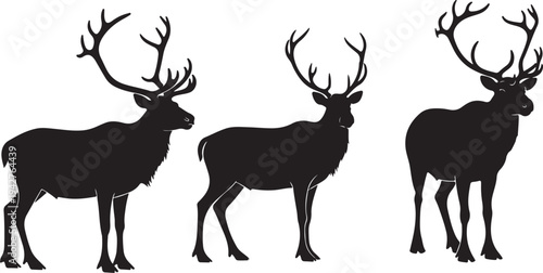 Three Black Silhouettes of Deer with Large Antlers Standing