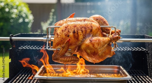 A whole roasted chicken rotates on a metal spit inside a charcoal grill. Flames engulf the chicken, creating a smoky atmosphere.