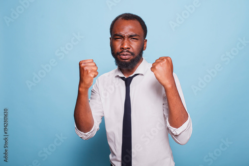 African american individual fighting with their problems at work having a combative demeanor Defensive black man boxing always on guard with intimidating posture fighting conflict for victory.