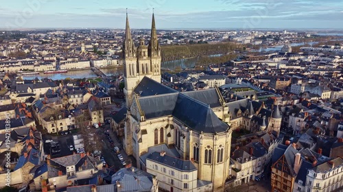 Saint-Maurice Cathedral overlooking the historic city center and the Maine river in Angers, France. Aerial forward