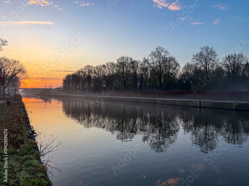 Tranquil sunset reflection on lake in Belgian countryside, Campine region, Antwerp province