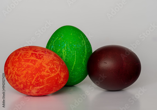 Easter eggs painted in different colors with unusual patterns on a white background, front view