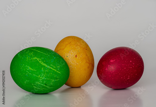 Easter eggs painted in different colors with unusual patterns on a white background, front view