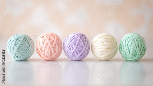 Colorful yarn balls lined up on a table with soft background