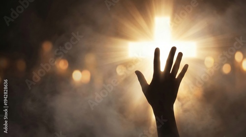Woman raising hand toward glowing cross in dark room. Christian worship and prayer service. Easter celebration, religious faith and spiritual devotion concept. Light in darkness.