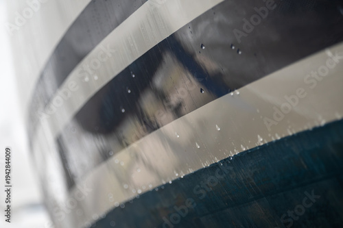 Sailboats on land in foggy marina boatyard during winter storage