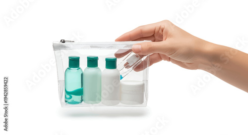 Hand holding clear toiletry bag with travel essentials