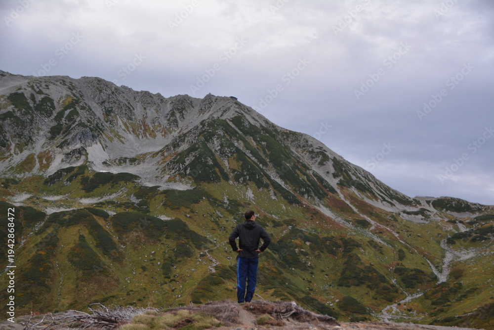 Naklejka premium 雄大な立山連峰を仰ぎ見る男性登山者