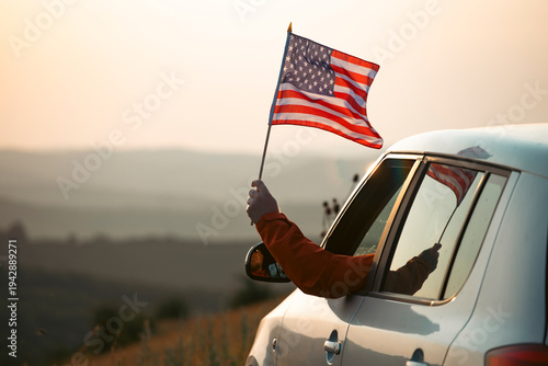 Canvastavla Man in the car holding a waving american USA flag.
