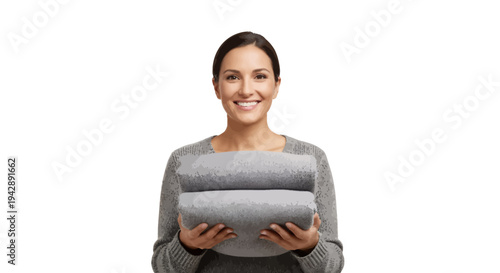 Smiling woman holding two gray pillows in modern home decor