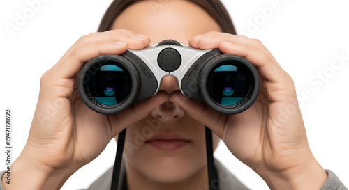 Woman looking through binoculars with focused expression
