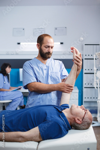 Εκτύπωση καμβά Male elderly patient receiving osteopathic care from a medical practitioner for arm pain