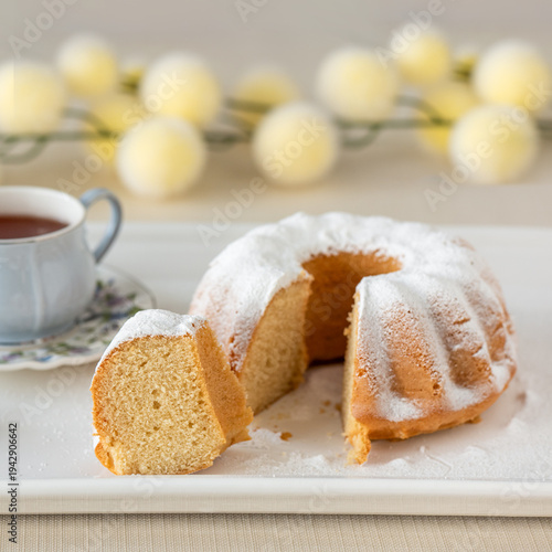 Traditional Easter bundt cake with powdered sugar and Easter bunny decoration