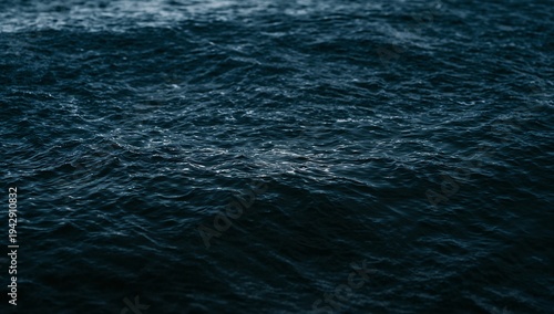 Rippling dark ocean surface showing textured small swells offshore, with subtle highlights
