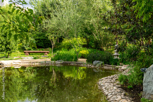 Decorative pond in the summer park. Garden landscape